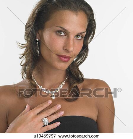 Stock Photo - Studio shot of woman wearing fancy jewelry. Fotosearch