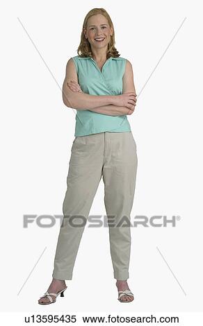 Studio shot of woman with arms crossed View Large Photo Image Stock Photography - Studio shot of woman with arms crossed. Fotosearch