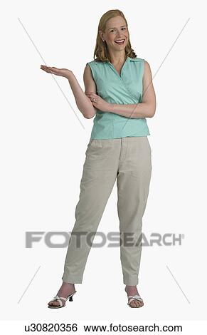 Studio shot of woman with hand held out to side View Large Photo Image Stock Photograph - Studio shot of woman with hand held out to side. Fotosearch