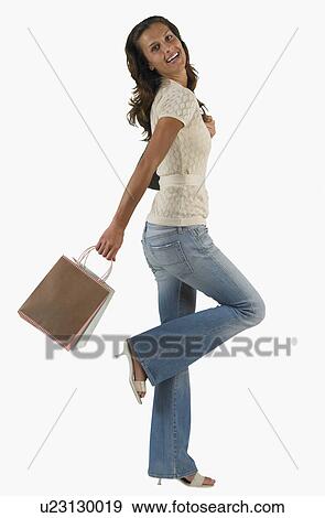 Studio shot of woman with holding shopping bag View Large Photo Image Stock Photo - Studio shot of woman with holding shopping bag. Fotosearch