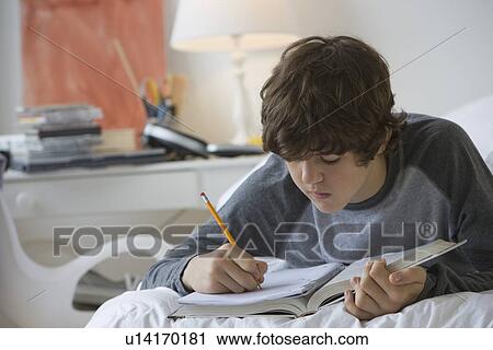 Teenaged boy doing homework View Large Photo Image Stock Image - Teenaged boy doing homework. Fotosearch