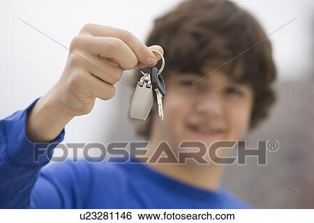 Stock Photograph - Teenaged boy holding car keys. Fotosearch