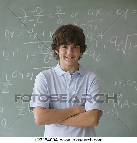 Teenaged boy in front of blackboard with math equations View Large Photo Image Picture - Teenaged boy in front of blackboard with math equations. Fotosearch