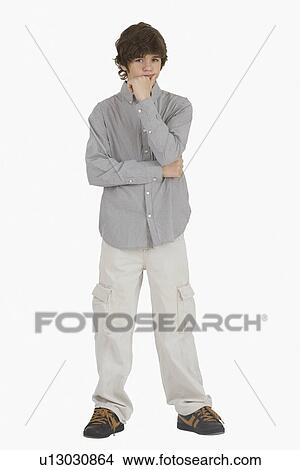Picture - Teenaged boy resting chin on hand. Fotosearch