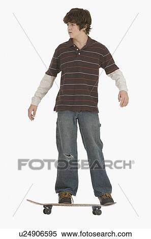 Stock Photography - Teenaged boy riding skateboard. Fotosearch