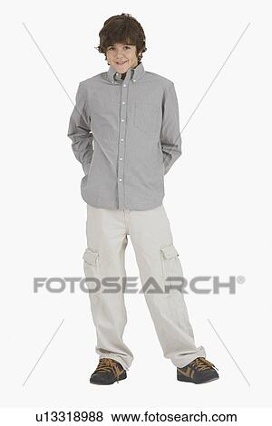 Stock Photo - Teenaged boy with hands behind back. Fotosearch