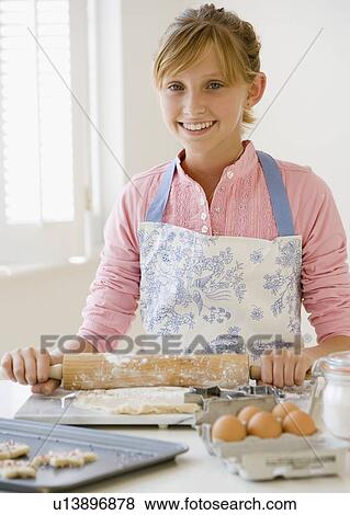 Teenaged girl baking cookies View Large Photo Image Stock Photo - Teenaged girl baking cookies. Fotosearch