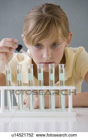 Teenaged girl dropping liquid in vials View Large Photo Image Stock Image - Teenaged girl dropping liquid in vials. Fotosearch