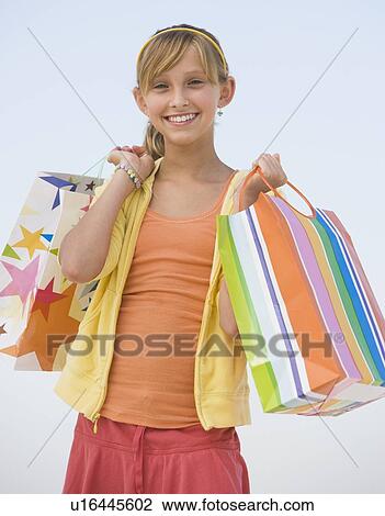 Teenaged girl holding shopping bags View Large Photo Image Stock Image - Teenaged girl holding shopping bags. Fotosearch