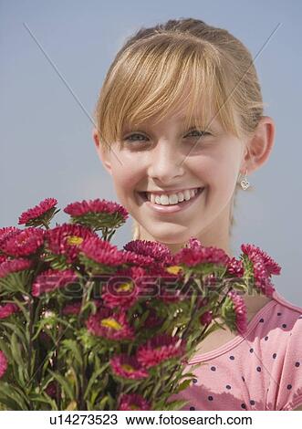 Teenaged girl holding wildflowers View Large Photo Image Stock Image - Teenaged girl holding wildflowers. Fotosearch