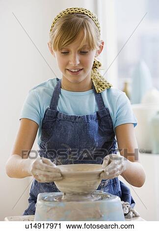 Teenaged girl sculpting on pottery wheel View Large Photo Image Stock Image - Teenaged girl sculpting on pottery wheel. Fotosearch