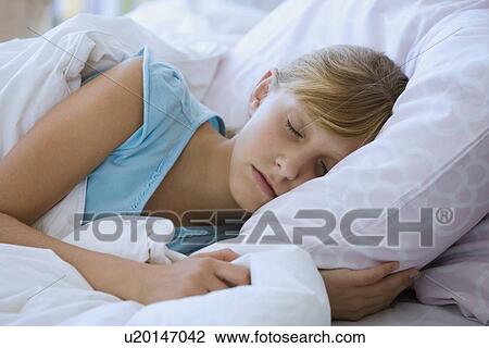 Teenaged girl sleeping in bed View Large Photo Image Stock Image - Teenaged girl sleeping in bed. Fotosearch