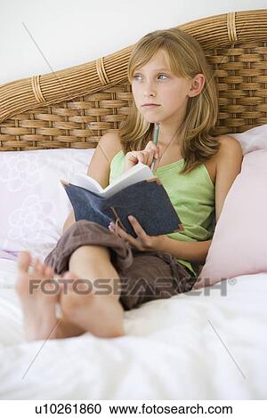 Teenaged girl writing in journal View Large Photo Image Stock Image - Teenaged girl writing in journal. Fotosearch