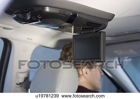 Stock Photo - Television screen in car with man driving. Fotosearch