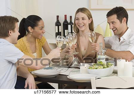 Stock Photo - Two couple toasting with wine. Fotosearch