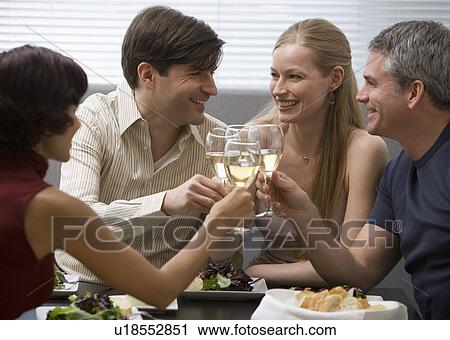 Two couples toasting at restaurant View Large Photo Image Stock Image - Two couples toasting at restaurant. Fotosearch