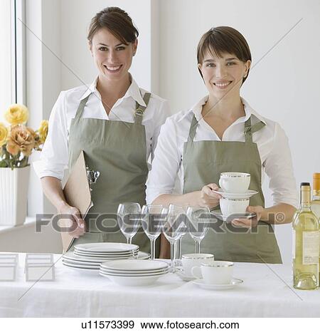 Two female caterers with dishware View Large Photo Image Stock Photo - Two female caterers with dishware. Fotosearch