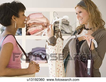 Two women at clothing store View Large Photo Image Stock Image - Two women at clothing store. Fotosearch