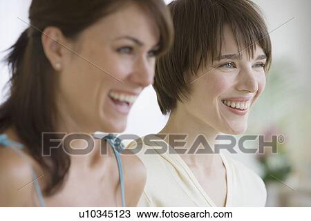 Two women laughing View Large Photo Image Stock Image - Two women laughing. Fotosearch