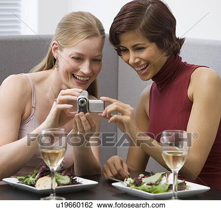 Two women looking at video camera View Large Photo Image Stock Image - Two women looking at video camera. Fotosearch
