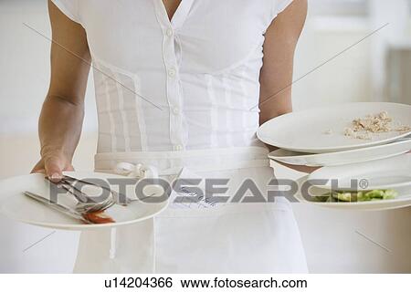 Waitress holding dirty plates View Large Photo Image Stock Photograph - Waitress holding dirty plates. Fotosearch