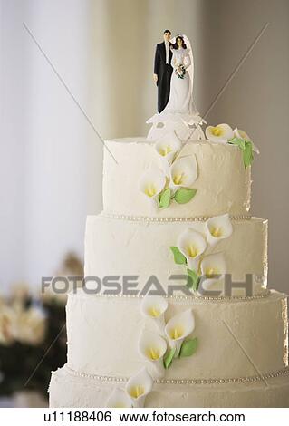 Stock Photograph - Wedding cake with bride and groom figurines. Fotosearch