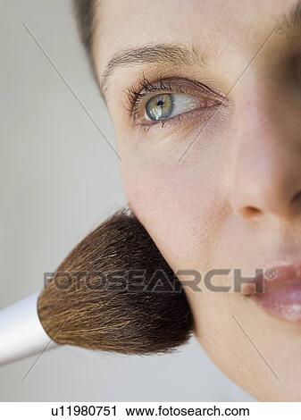 Woman applying make up with brush View Large Photo Image Stock Image - Woman applying make up with brush. Fotosearch