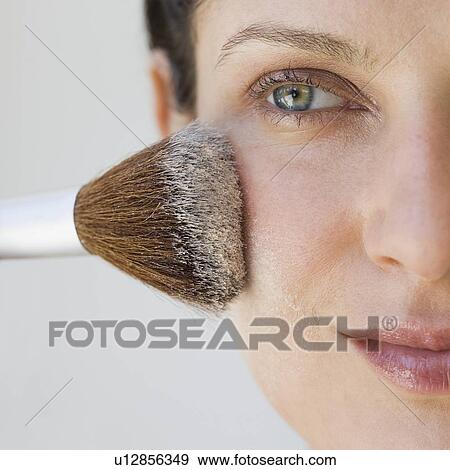 Stock Photo - Woman applying make up with brush. Fotosearch