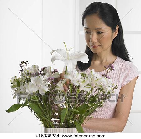 Woman arranging bouquet of flowers View Large Photo Image Picture - Woman arranging bouquet of flowers. Fotosearch