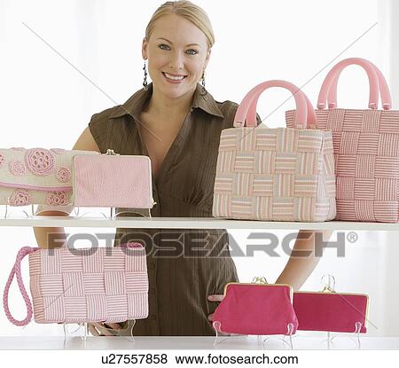 Woman behind shelves of purses View Large Photo Image Stock Photo - Woman behind shelves of purses. Fotosearch
