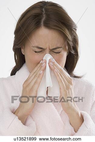 Woman blowing nose View Large Photo Image Stock Photo - Woman blowing nose. Fotosearch
