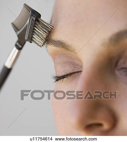 Picture - Woman brushing eyebrow. Fotosearch