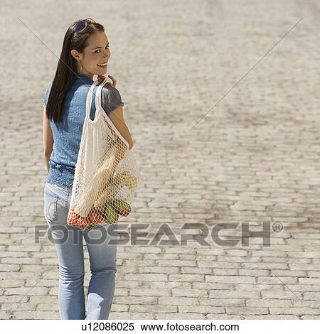 Woman carrying mesh bag of groceries View Large Photo Image Stock Photography - Woman carrying mesh bag of groceries. Fotosearch