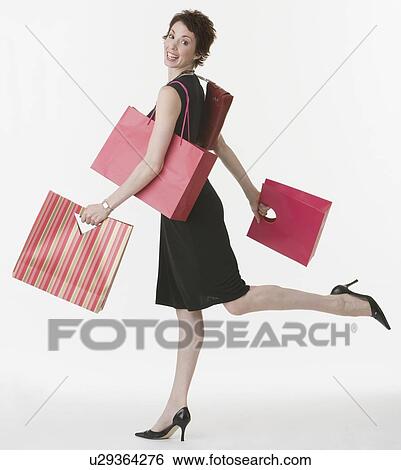 Woman carrying shopping bags View Large Photo Image Stock Photograph - Woman carrying shopping bags. Fotosearch