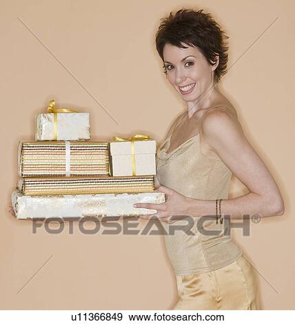 Woman carrying stack of gifts View Large Photo Image Stock Photo - Woman carrying stack of gifts. Fotosearch