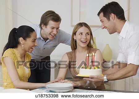 Woman celebrating birthday with friends View Large Photo Image Stock Photo - Woman celebrating birthday with friends. Fotosearch