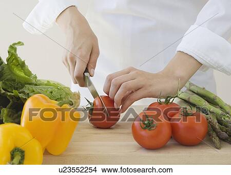 Woman chopping vegetables View Large Photo Image Picture - Woman chopping vegetables. Fotosearch