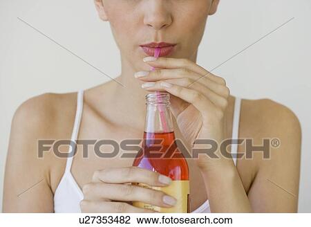 Woman drinking soda through straw View Large Photo Image Stock Image - Woman drinking soda through straw. Fotosearch