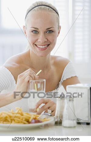 Woman eating at diner View Large Photo Image Stock Photo - Woman eating at diner. Fotosearch