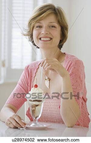 Woman eating ice cream sundae View Large Photo Image Stock Image - Woman eating ice cream sundae. Fotosearch