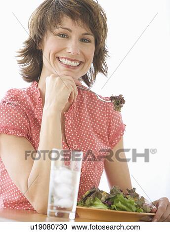 Stock Image - Woman eating salad. Fotosearch