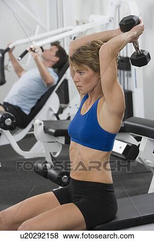 Stock Photo - Woman exercising with weight. Fotosearch