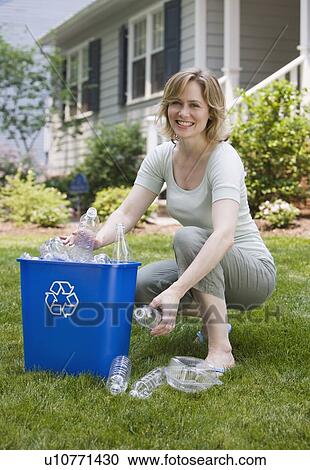 Woman filling recycling bin View Large Photo Image Stock Image - Woman filling recycling bin. Fotosearch