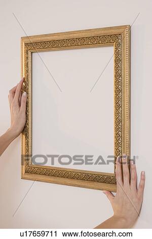 Woman hanging empty picture frame View Large Photo Image Stock Image - Woman hanging empty picture frame. Fotosearch