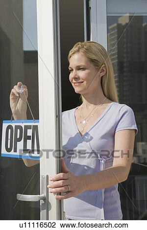 Woman hanging Open sign in doorway View Large Photo Image Stock Image - Woman hanging Open sign in doorway. Fotosearch
