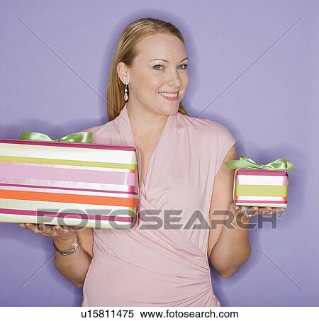 Woman holding big and small gifts View Large Photo Image Stock Photography - Woman holding big and small gifts. Fotosearch