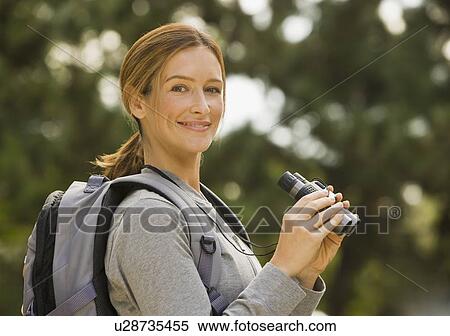 Woman holding binoculars View Large Photo Image Stock Photography - Woman holding binoculars. Fotosearch