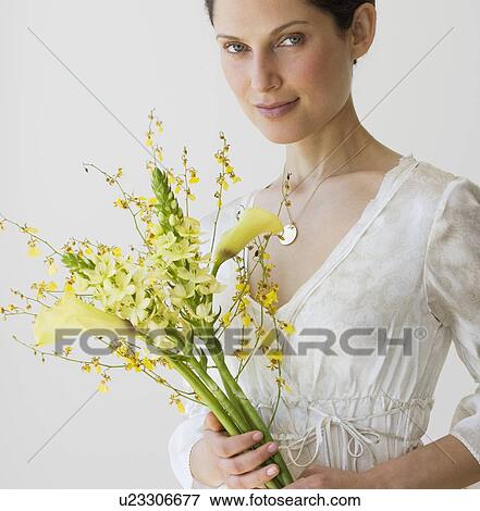 Stock Photo - Woman holding bouquet of flowers. Fotosearch