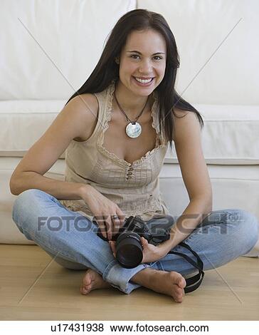 Woman holding camera on floor View Large Photo Image Stock Photo - Woman holding camera on floor. Fotosearch