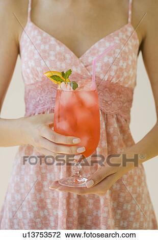 Woman holding cocktail View Large Photo Image Stock Image - Woman holding cocktail. Fotosearch